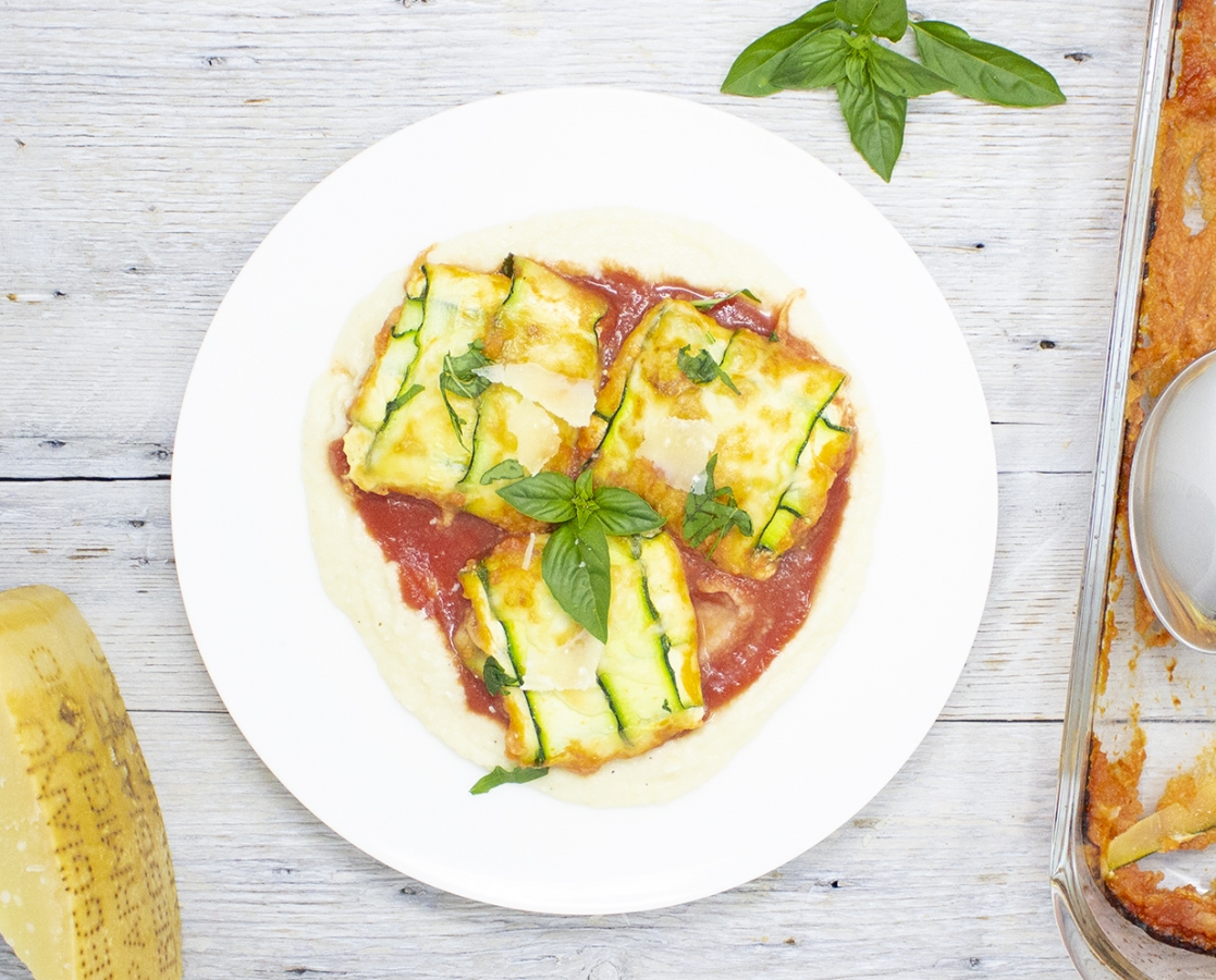 Zucchini Fazzoletti, stuffed with cheese, served with cauliflower Alfredo sauce and tomato coulis