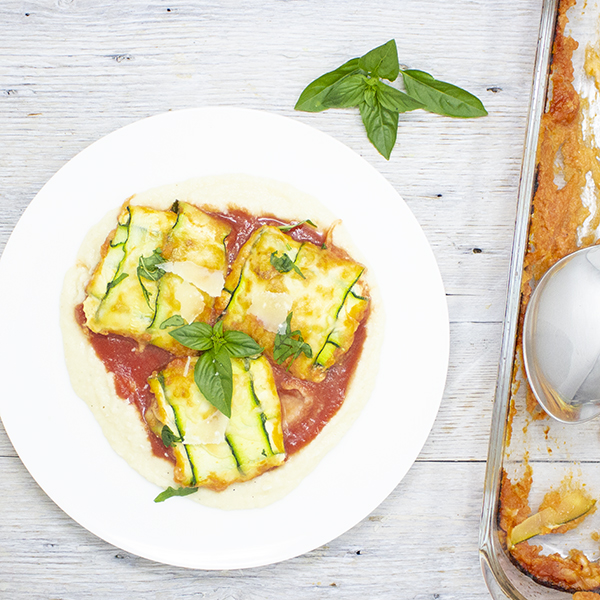 Zucchini Fazzoletti, stuffed with cheese, served with cauliflower Alfredo sauce and tomato coulis