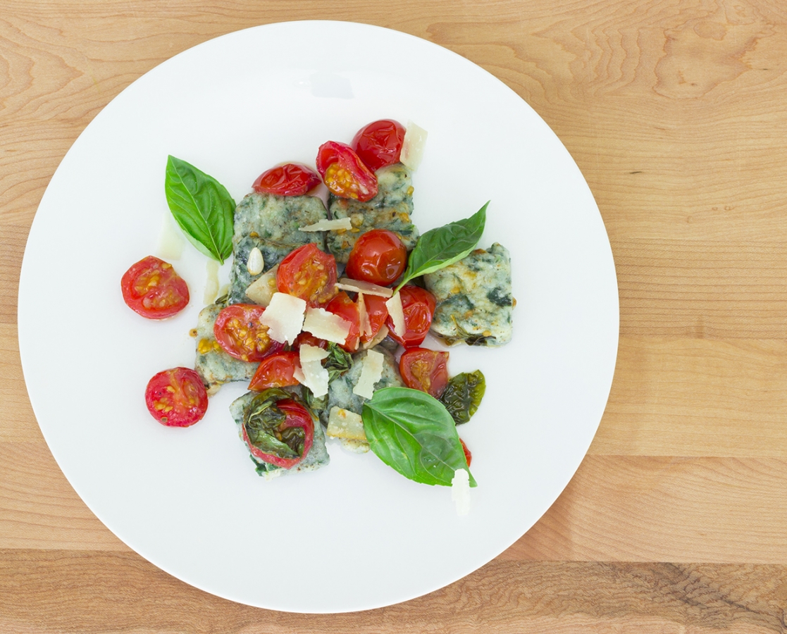 Gluten-free spinach ricotta gnocchi with garlic and fresh Basil confit cherry tomatoes