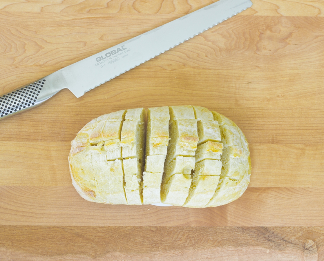 Fresh bread loaf with garlic, melted cheese and Balsamumm drizzle