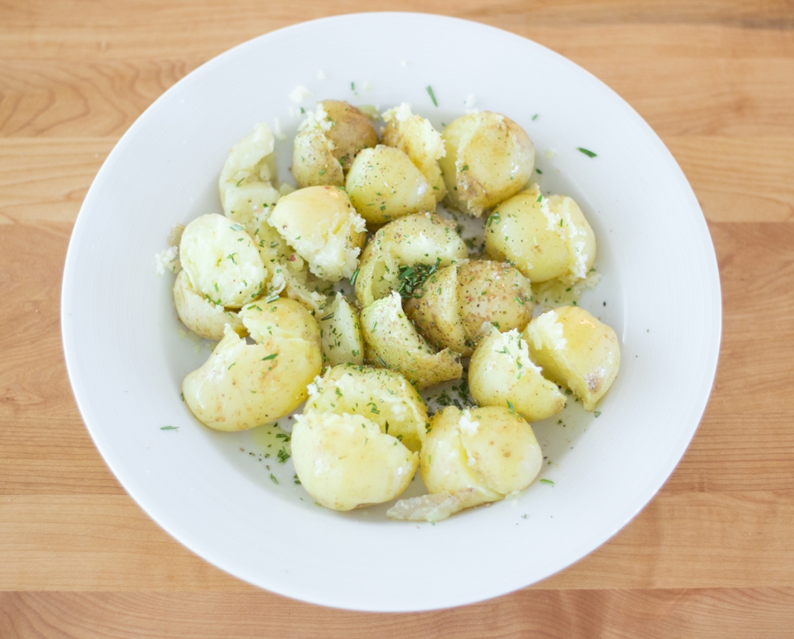 Boiled potatoes with olive oil and fresh rosemary