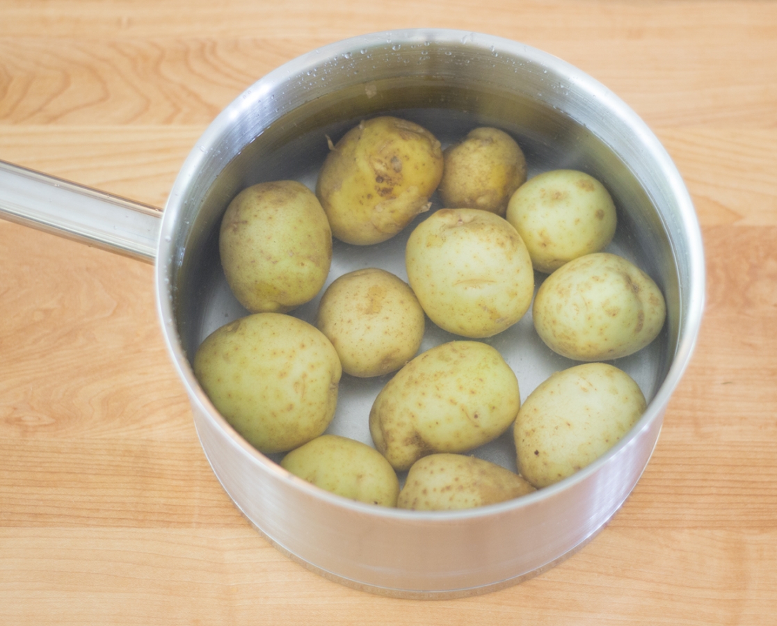 Boiled potatoes with olive oil and fresh rosemary