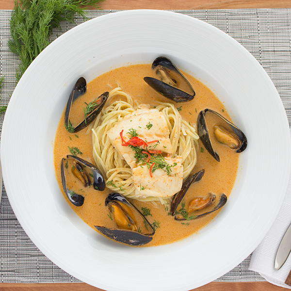 Thai style cod and mussels zuppetta on fresh spaghetti