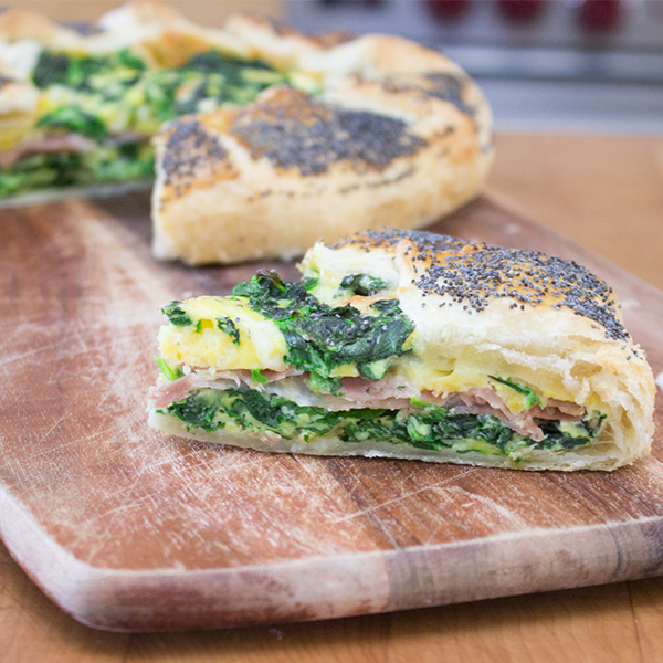 Frittata baked in puff pastry with spinach, cheese and prosciutto