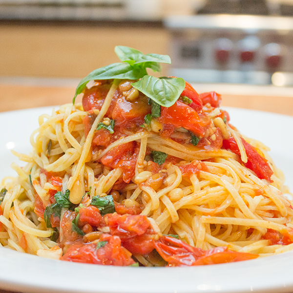 Spaghetti with slow roasted cherry tomato, pine nuts and fresh basil