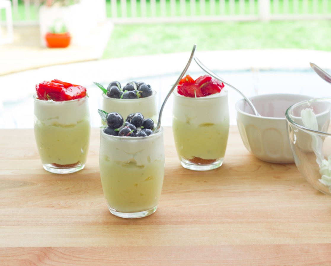 Lime-coconut custard verrine, on amaretto cookie topped with whipped cream and marinated fruits